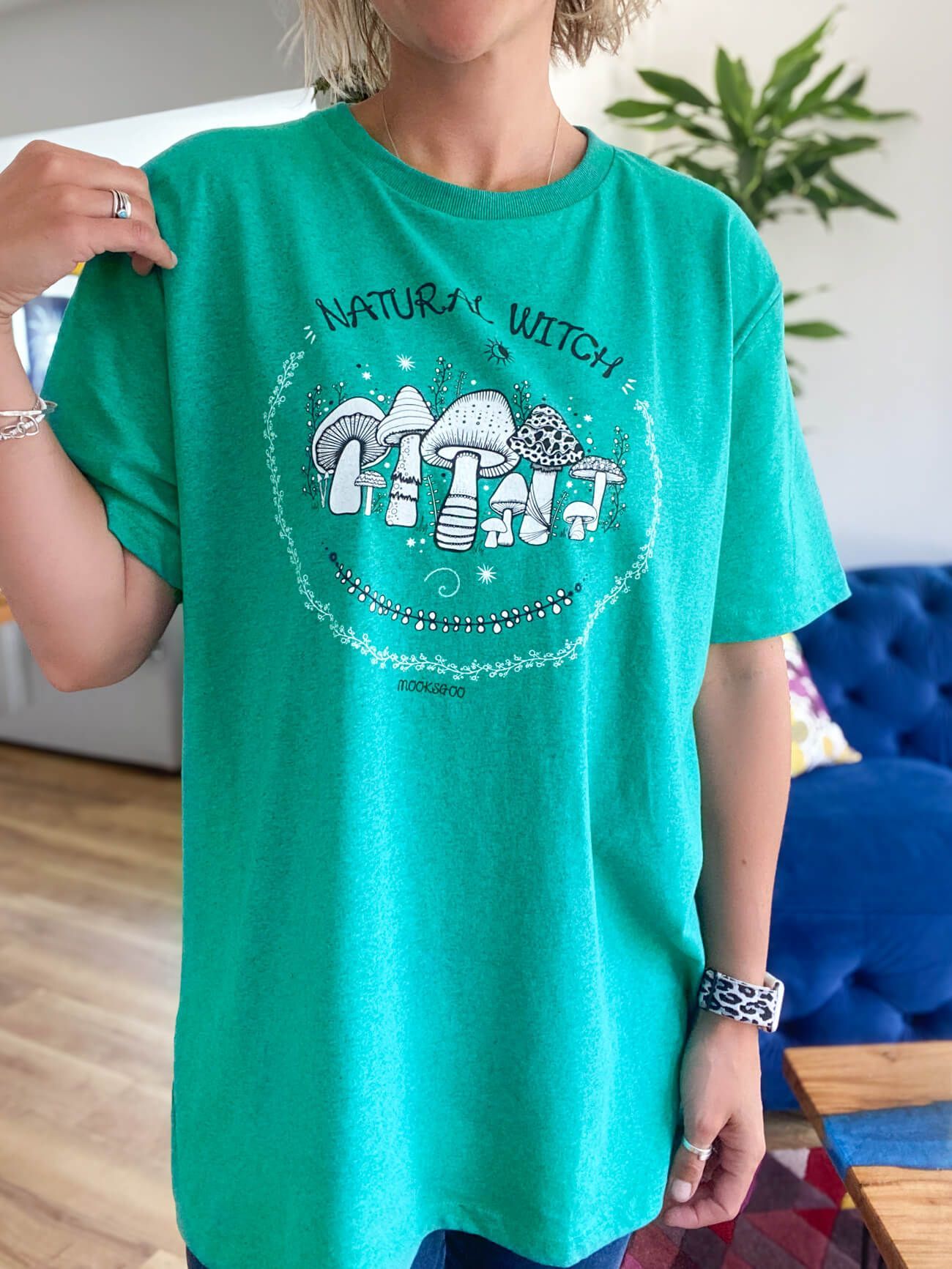 Natural witch with mushroom illustrations on a jade turquoise green recycled organic cotton oversized t-shirt, designed by MooksGoo, made on the Isle of Wight
