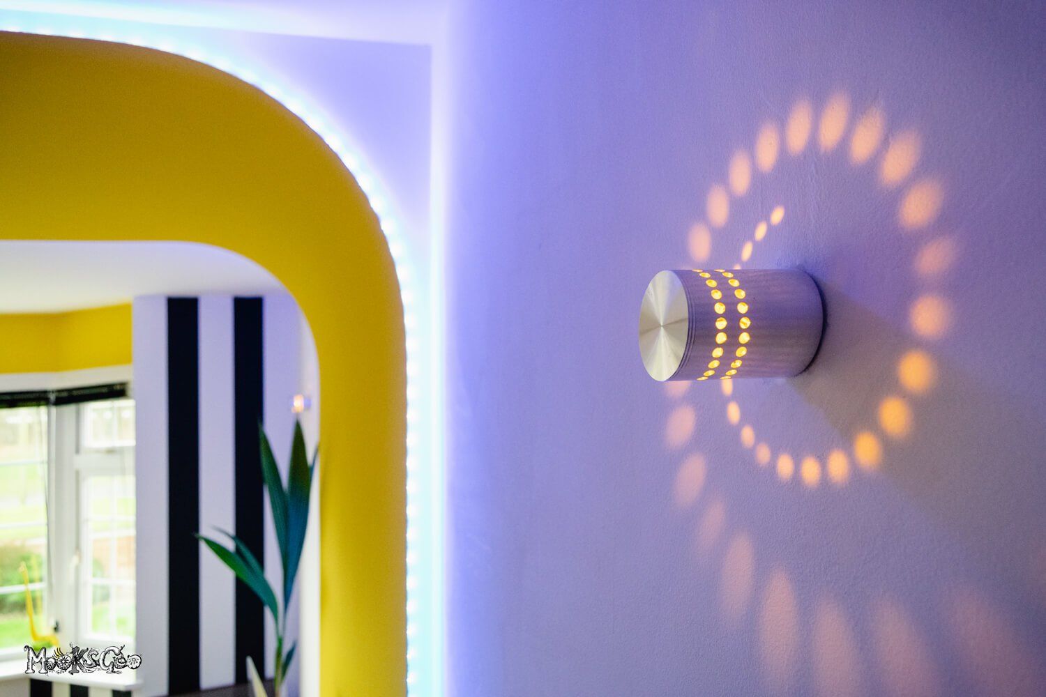 Funky home office inspiration with sunshine yellow walls and black and white stripey wallpaper with a bright curved feature wall. Interior design by MooksGoo