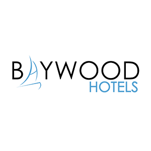 The logo for baywood hotels has a sailboat on it.