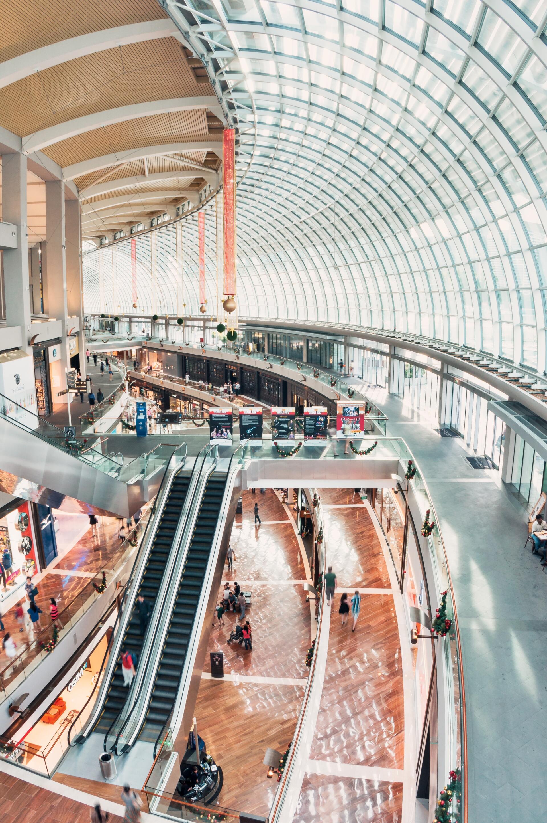 An aerial view of a shopping mall with escalators going up and down.