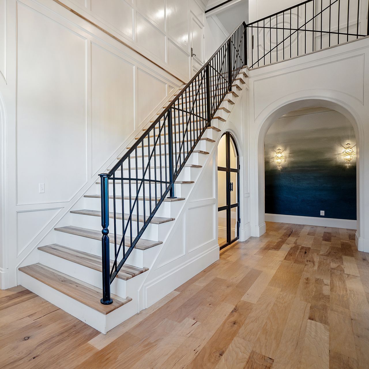 A staircase with wooden steps and a black railing