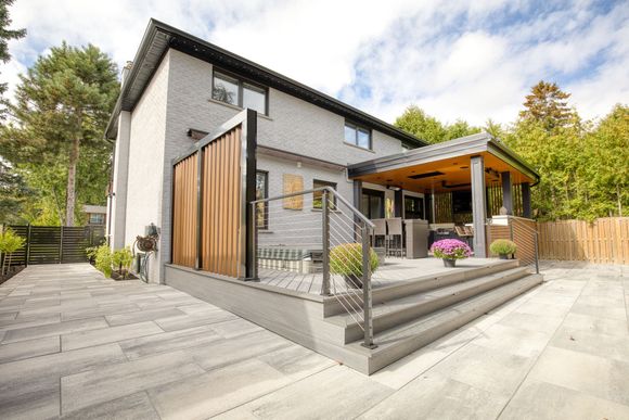 A large house with a porch and a walkway leading to it.