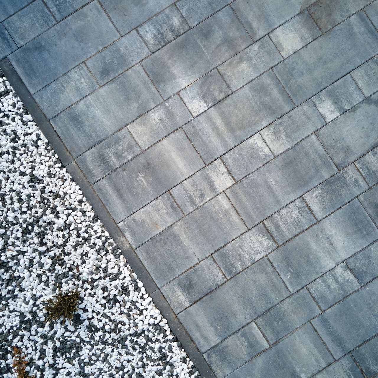 An aerial view of a driveway with bricks and gravel.