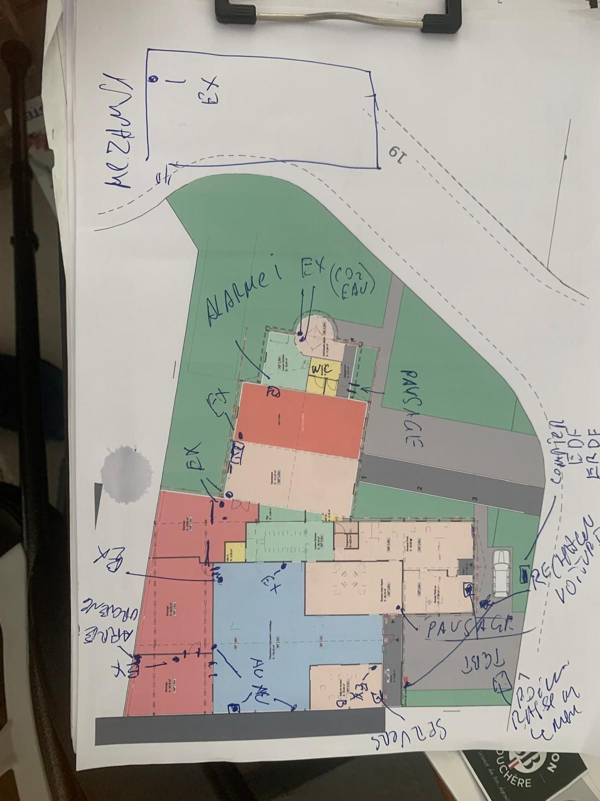 Plan d’évacuation d’une imprimerie à Clermont-Ferrand avec repérage des issues, extincteurs, alarmes incendie, points de rassemblement et zones de circulation.