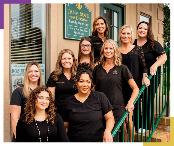 Dr. Jana Boyd standing in front of their Family Dentistry sign