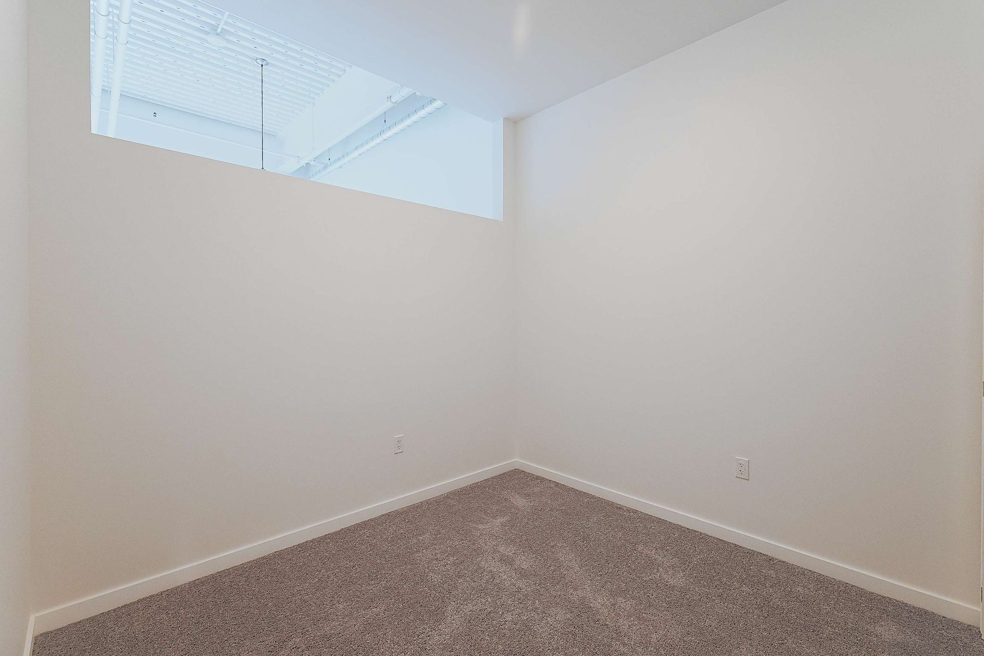 There is a window in the corner of the room.