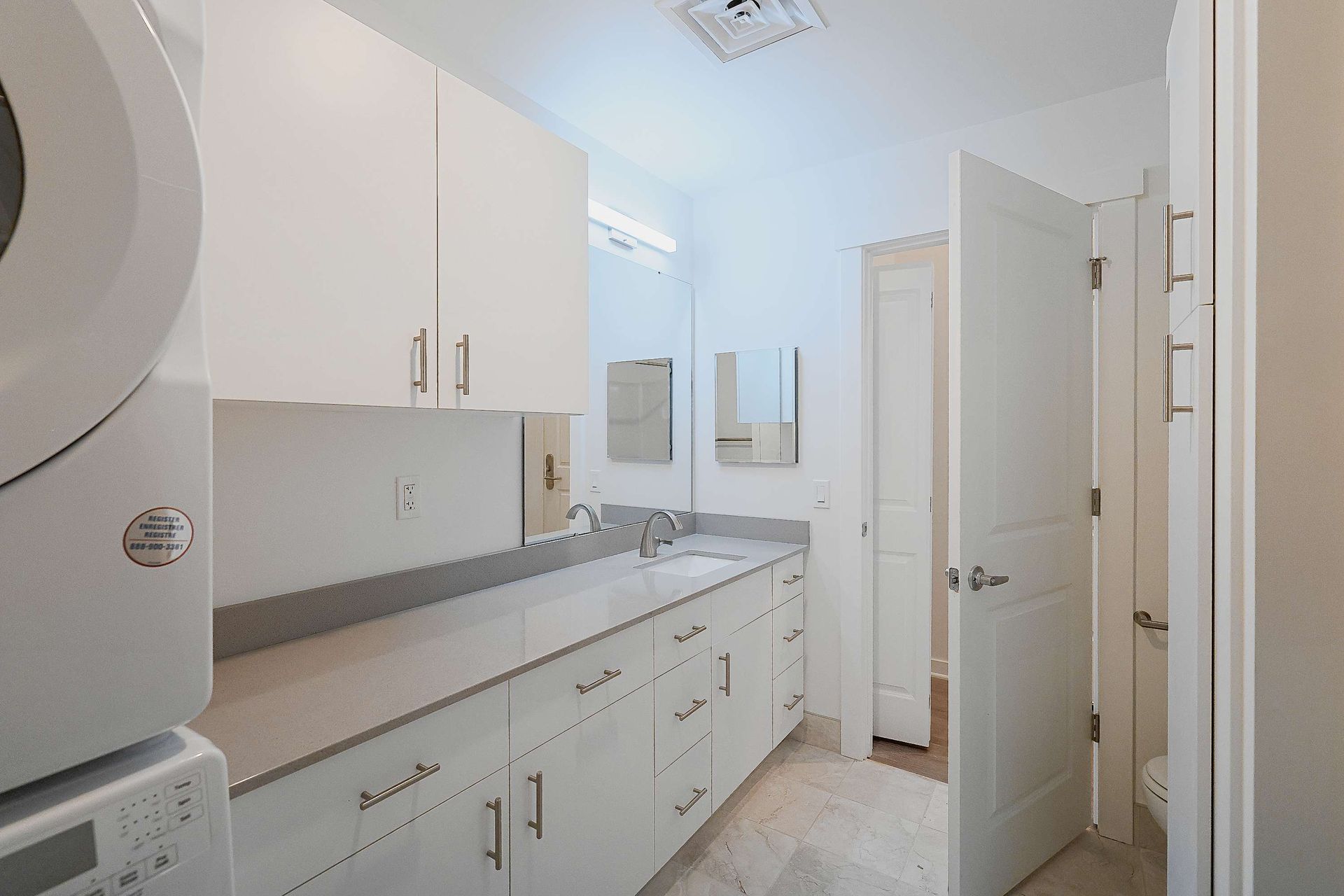 A laundry room with a washer and dryer and a sink.