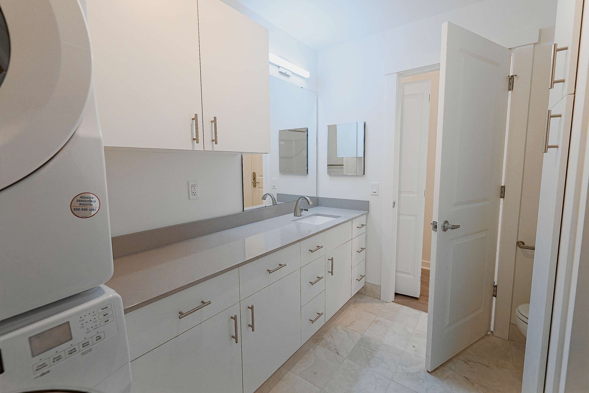 A laundry room with a washer and dryer and a sink.