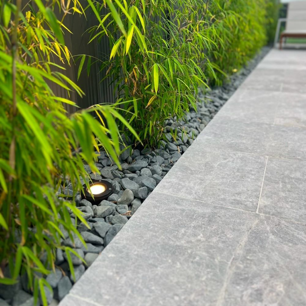 A Stone Walkway Surrounded by Bamboo Plants and Rocks — Billabong Pool Co in Wollongong, NSW