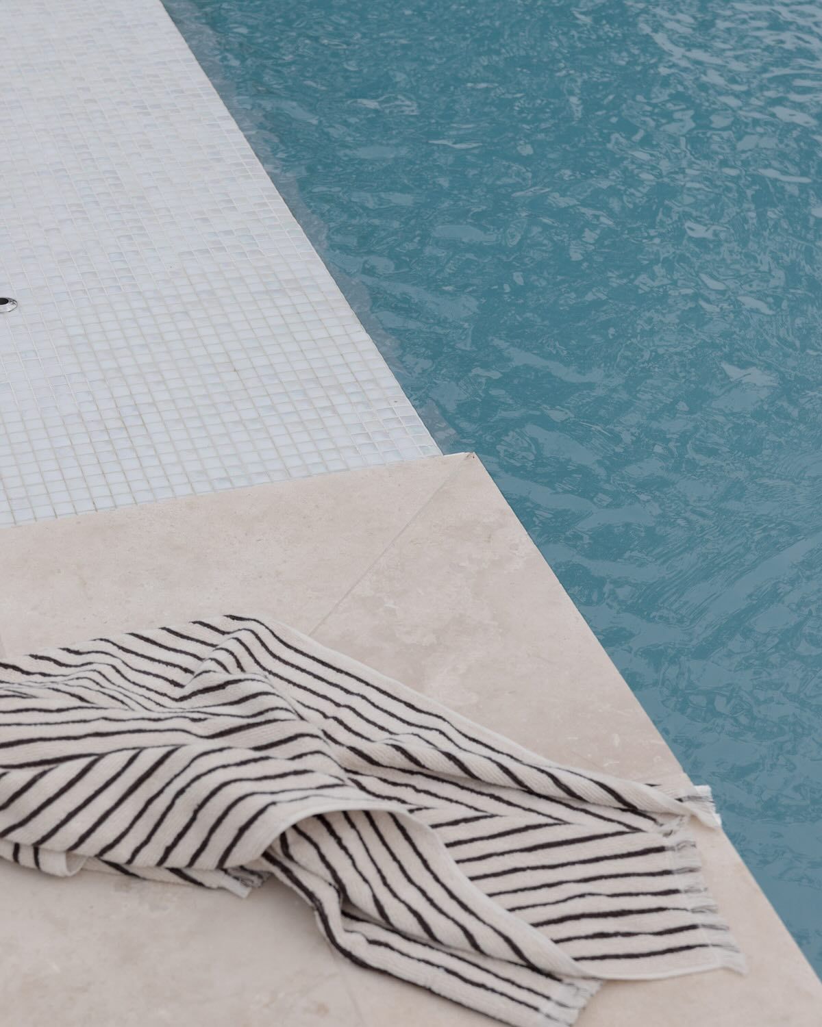 A Towel Is Laying on The Edge of A Swimming Pool — Billabong Pool Co in Smeaton Grange, NSW
