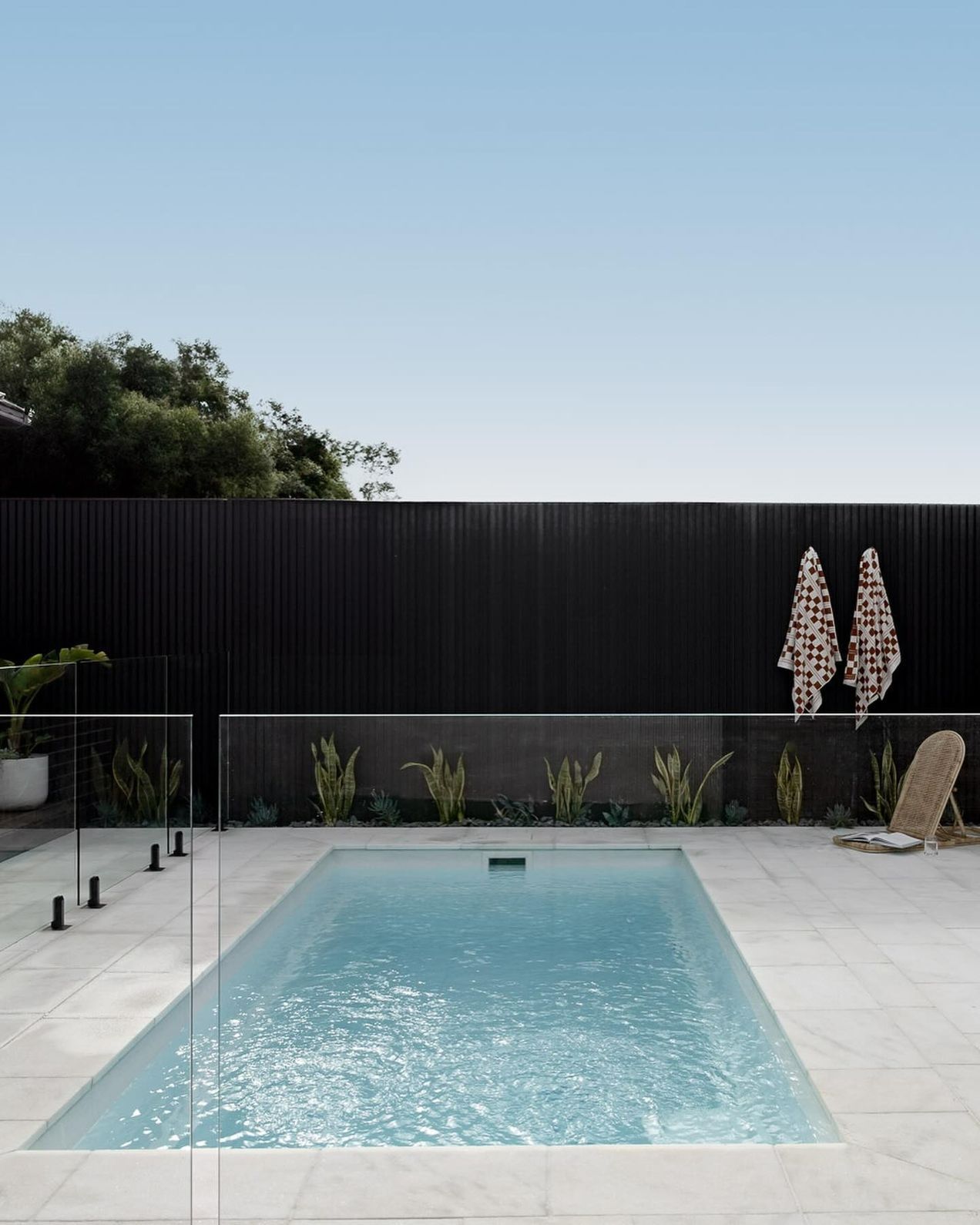 A Large Swimming Pool with A Black Fence Surrounding It — Billabong Pool Co in Smeaton Grange, NSW