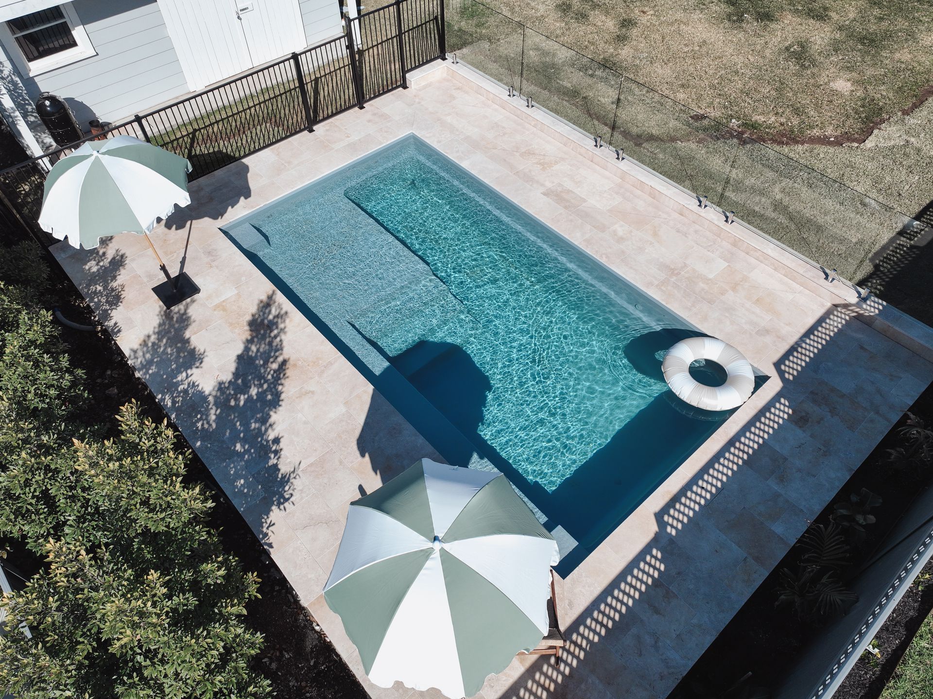 A Towel Is Laying on The Edge of A Swimming Pool — Billabong Pool Co in Smeaton Grange, NSW