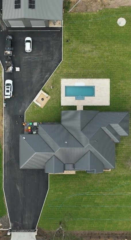 Aerial View of a House With a Driveway, Lawn, and Rectangular Backyard Pool — Billabong Pool Co in Smeaton Grange, NSW