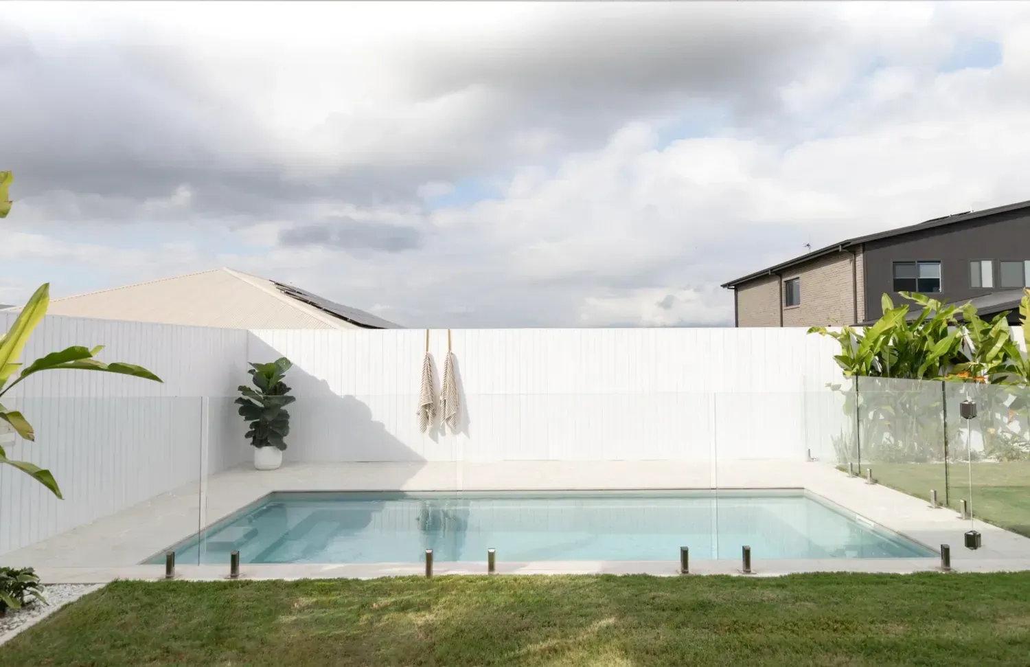 A Large Swimming Pool in The Backyard of A House — Billabong Pool Co in Smeaton Grange, NSW