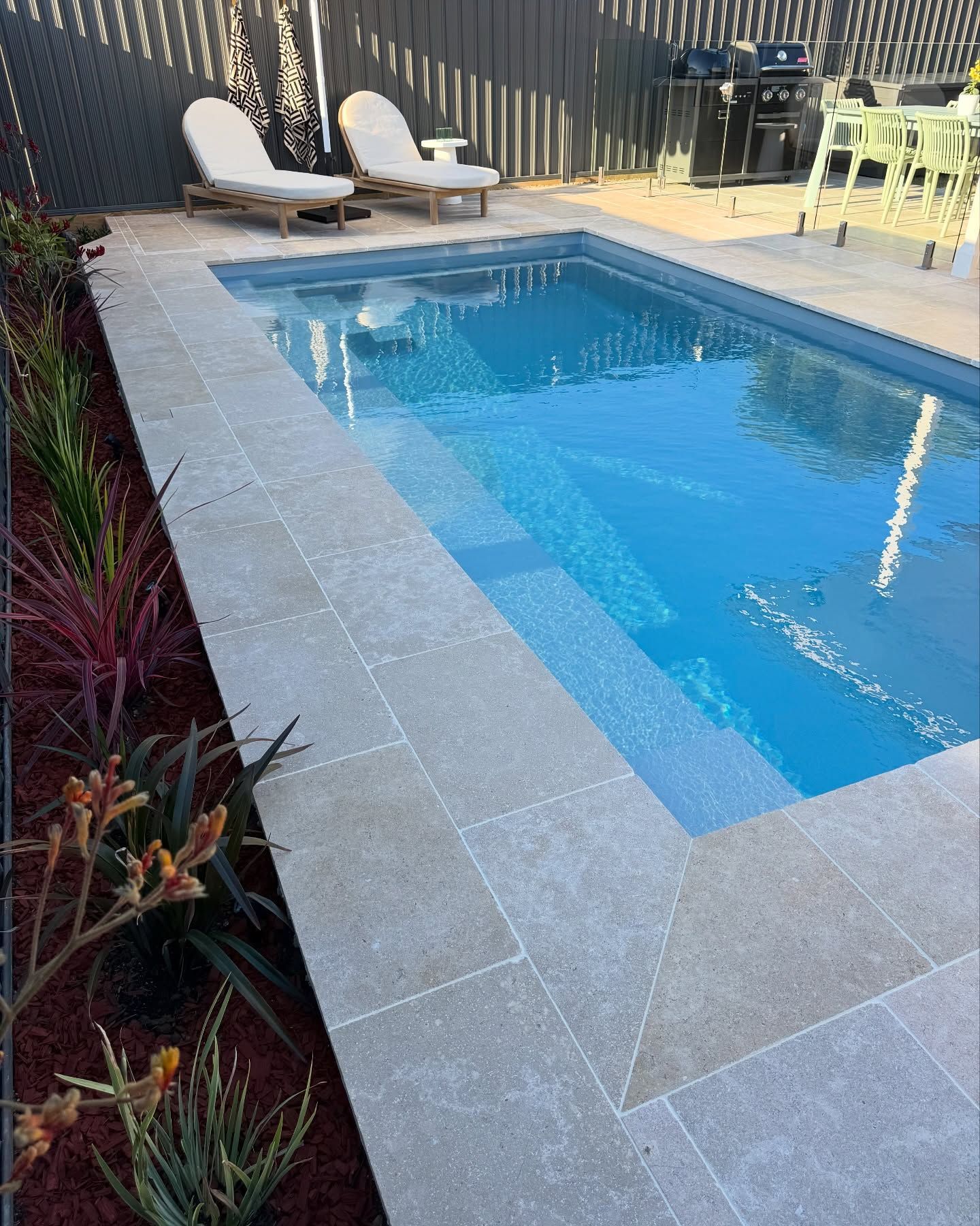 Top-down View of a Rectangular Turquoise Pool With Lounge Chairs and Umbrellas on a Sunlit Terrace — Billabong Pool Co in Wollongong, NSW