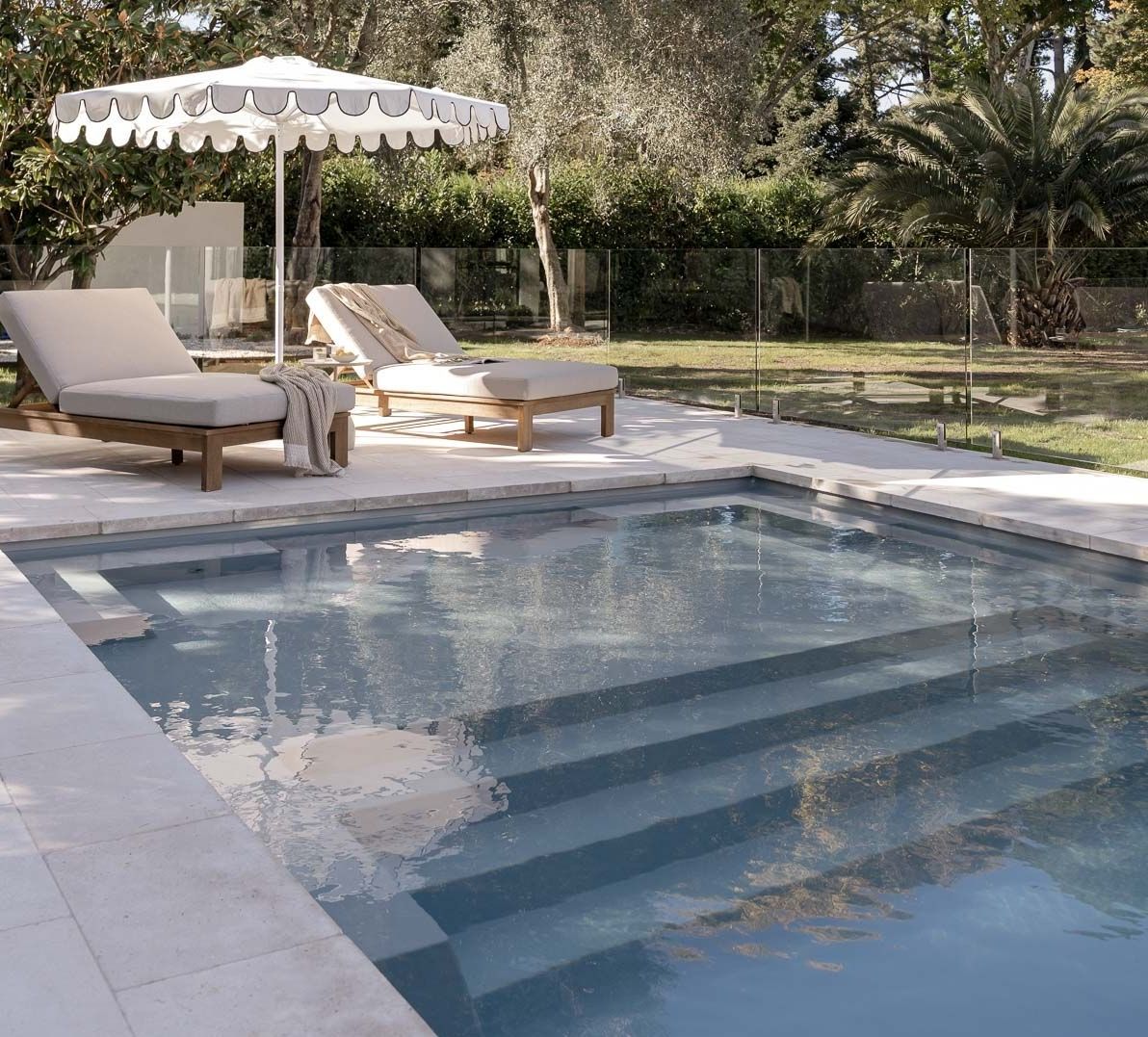 Backyard Pool With Stone Steps, Two Lounge Chairs, and a White Canopy Under Trees — Billabong Pool Co in Wollongong, NSW