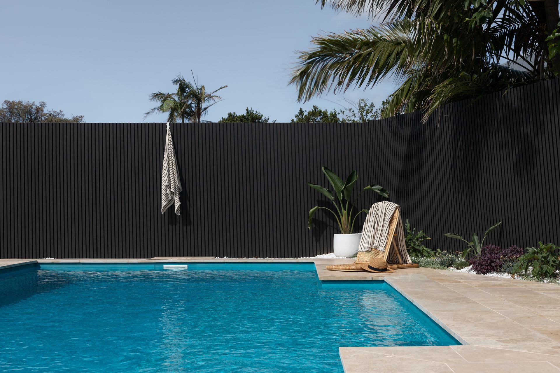 Backyard Pool With Turquoise Water, Black Fence, Lounge Chair — Billabong Pool Co in Smeaton Grange, NSW