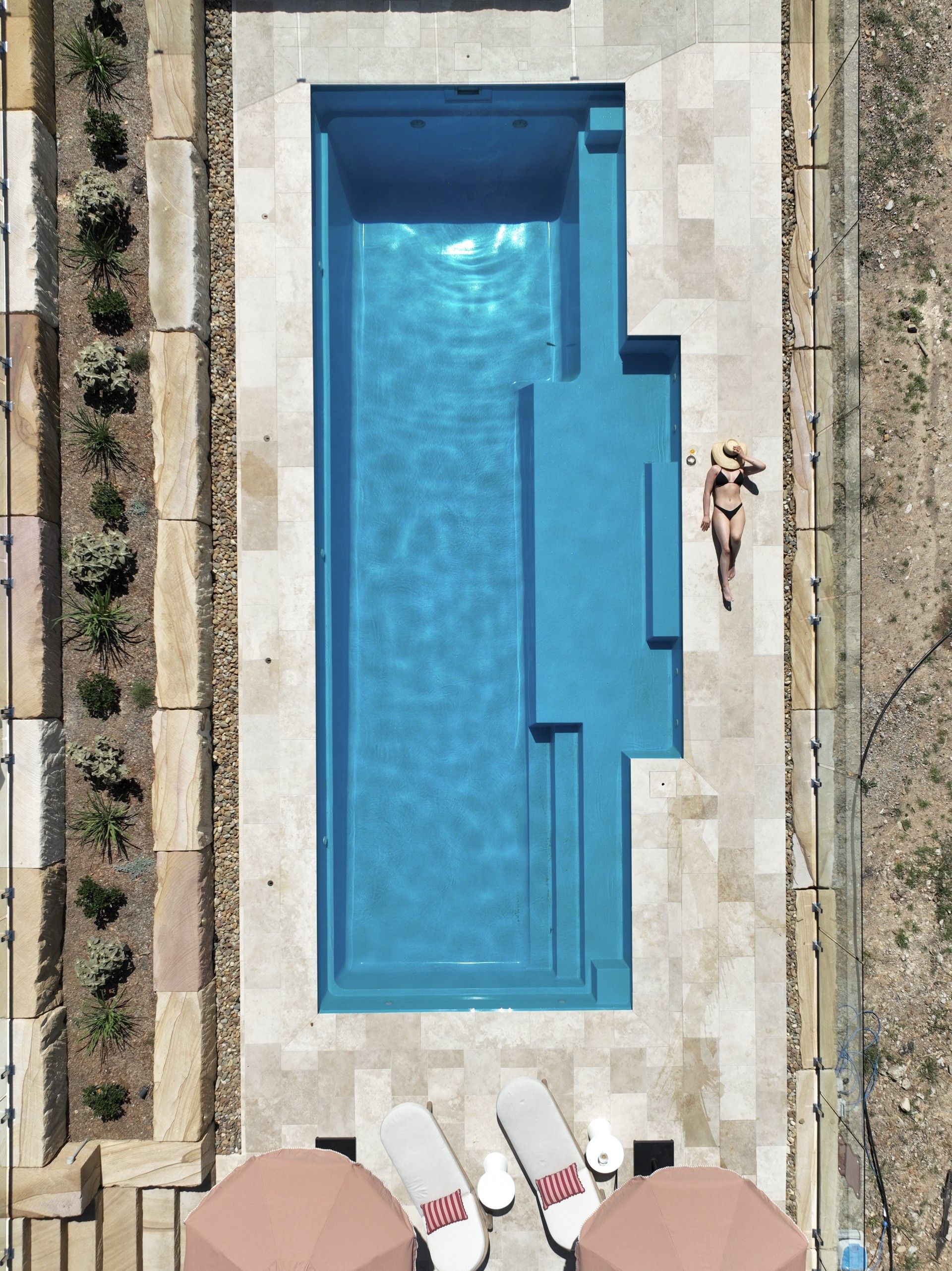 Top-down View of a Hotel Pool With a Person Floating — Billabong Pool Co in Smeaton Grange, NSW