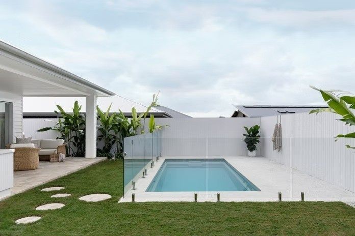 A Large Swimming Pool in The Backyard of A House — Billabong Pool Co in Smeaton Grange, NSW