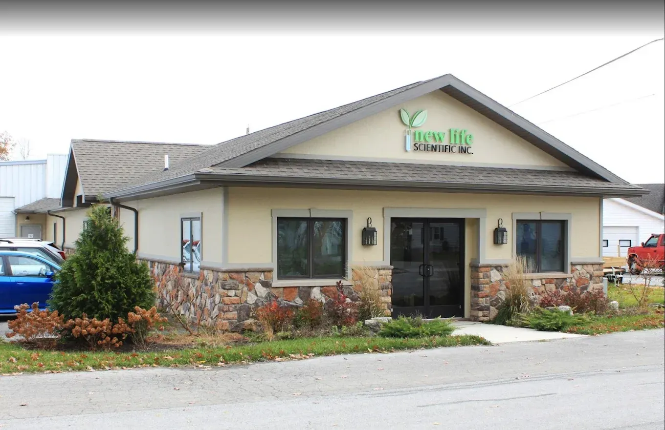 Tan building with stone accents, windows, and the logo