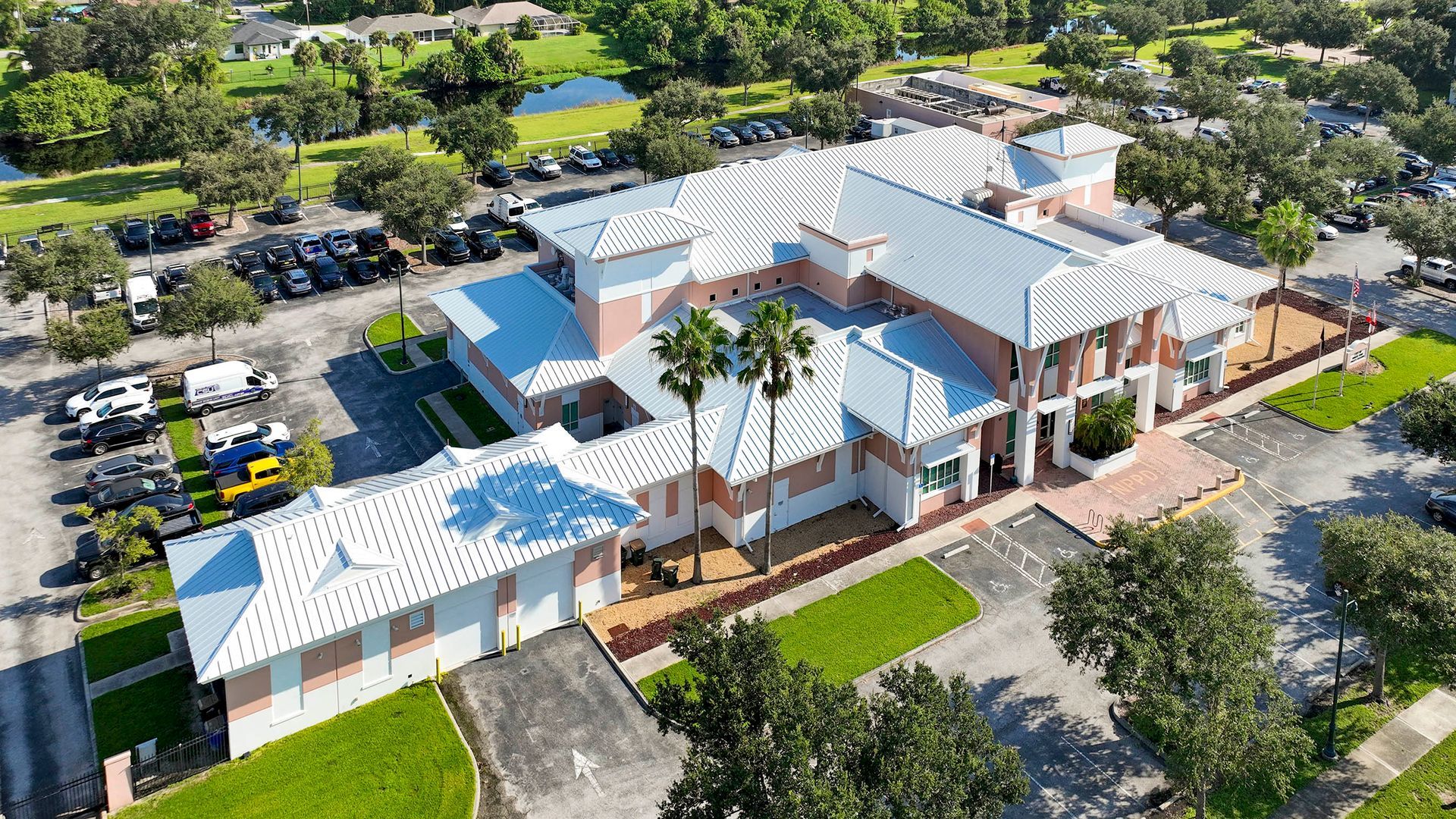 Large institutional building with metal roofs, shown as a commercial roofing example