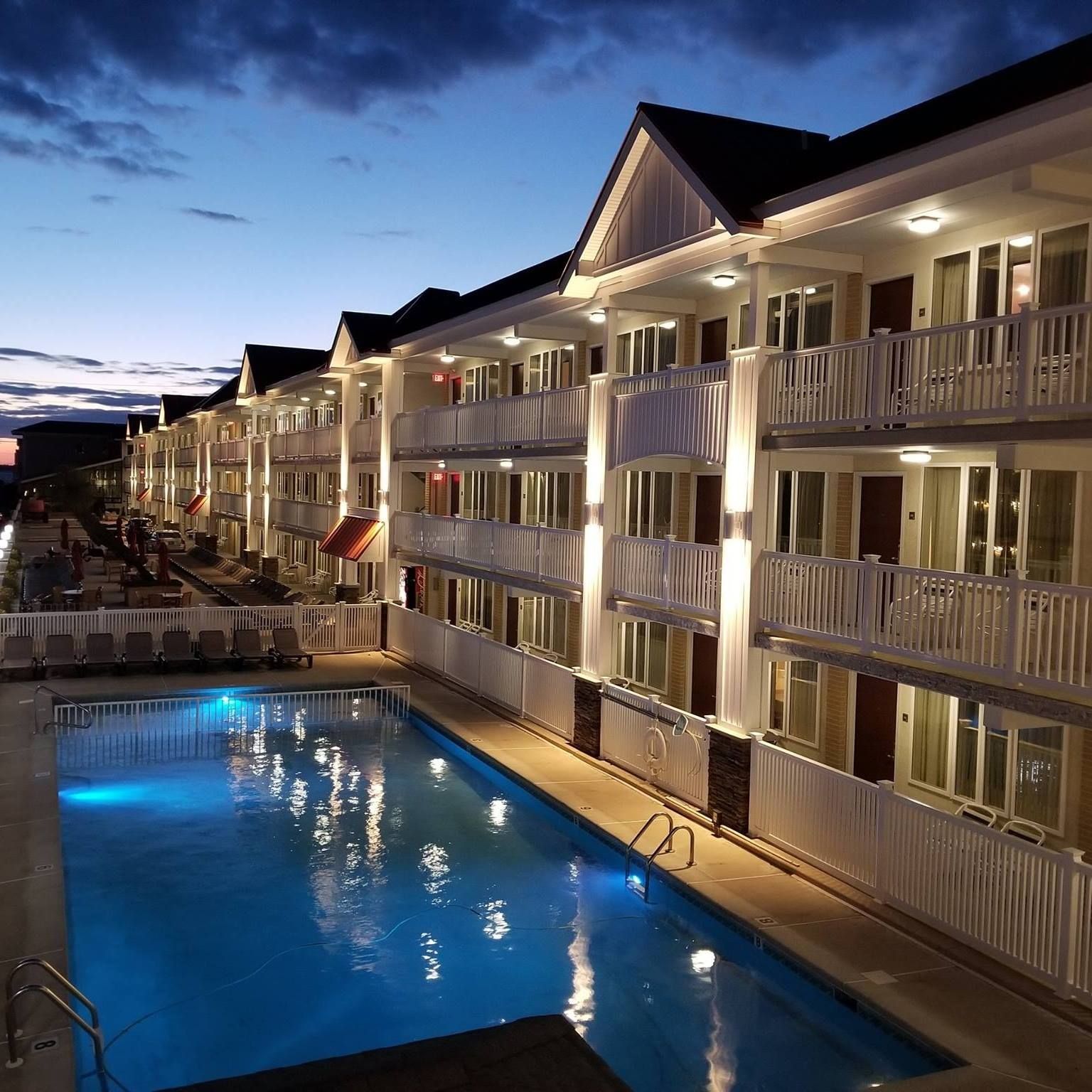 A large building with a swimming pool in front of it