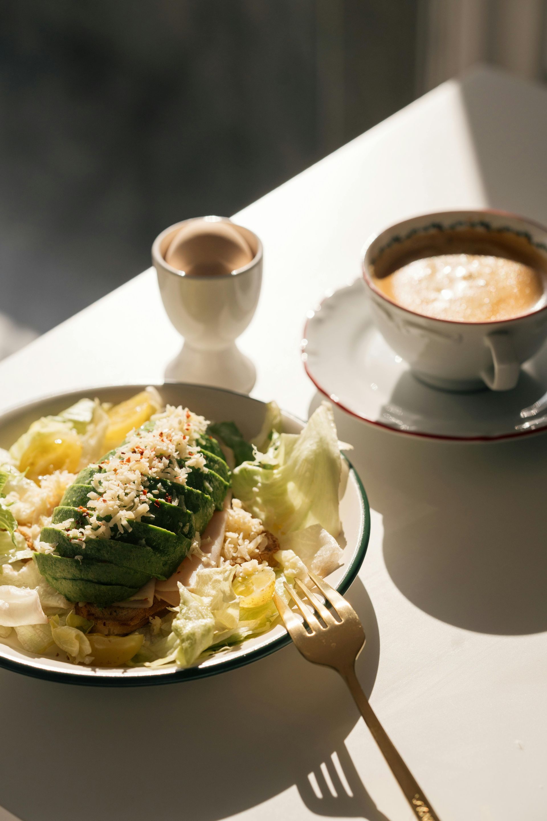 A plate of food and a cup of coffee on a table.
