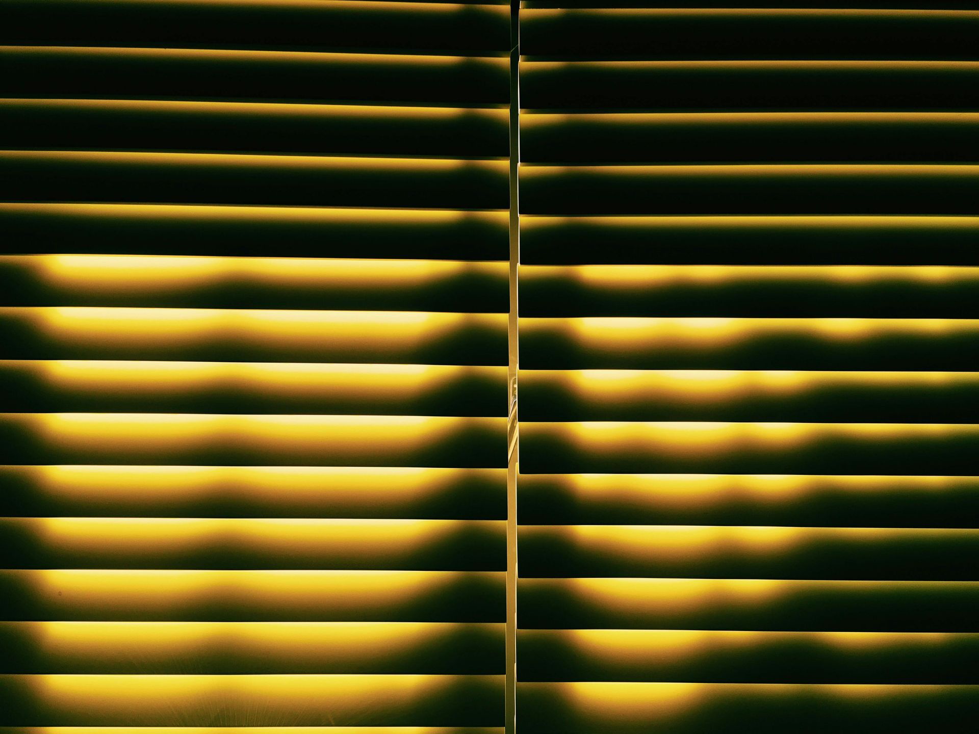 A window with wooden shutters on a brick wall