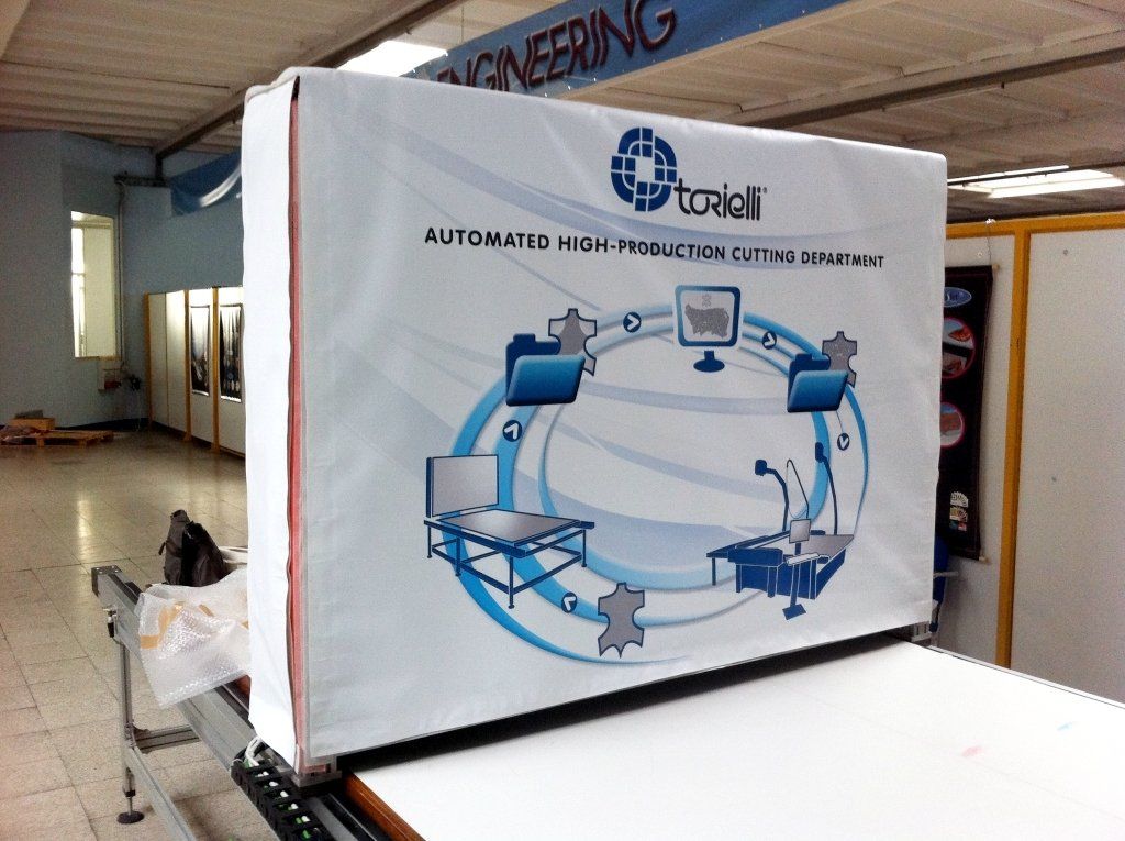 Espositore rettangolare bianco con logo aziendale blu e bianco, su un tavolo bianco.
