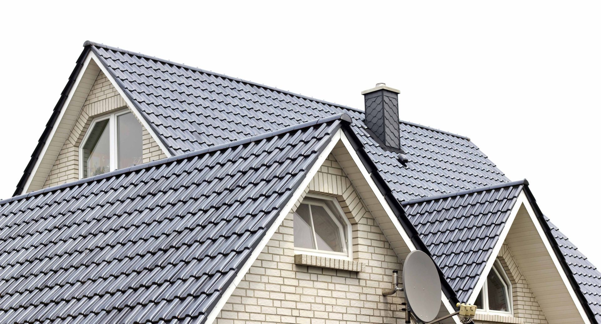 Close-up of a house with gray shingled roof, white brick walls, and a satellite dish Close-up of a house with gray shingled roof, white brick walls, and a satellite dish