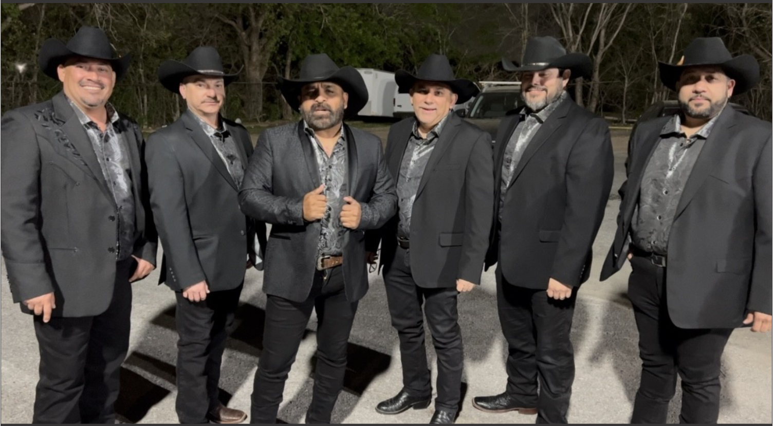 Grupo Orgullo in suits and cowboy hats are posing for a picture.