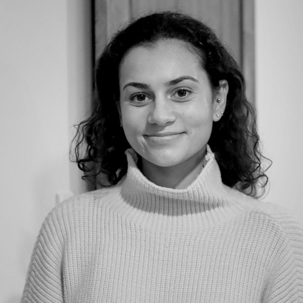 A black and white photo of a woman wearing a turtleneck sweater.