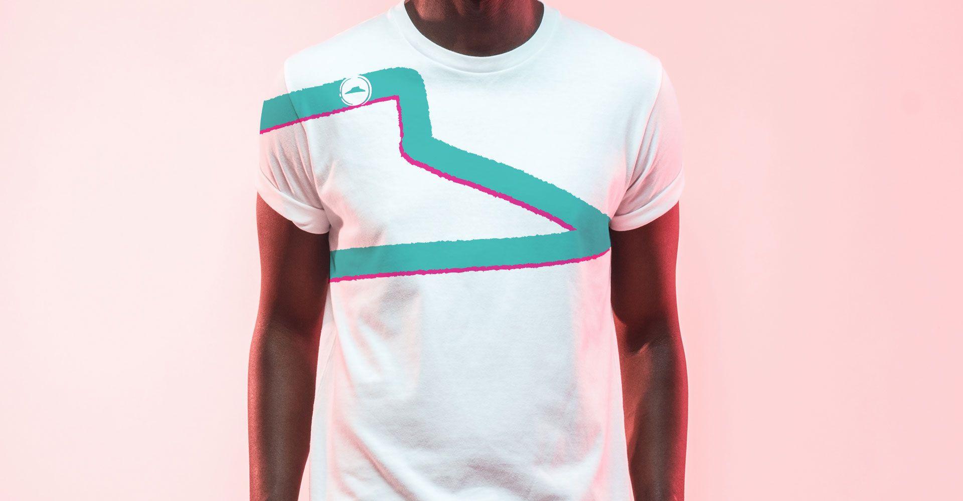 A man is wearing a white t-shirt with a blue and pink design on it.