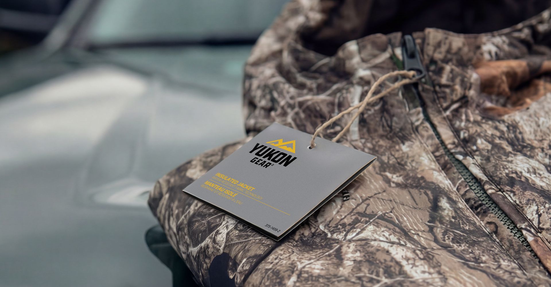 A woman wearing a conical hat is riding a bike down a busy street.