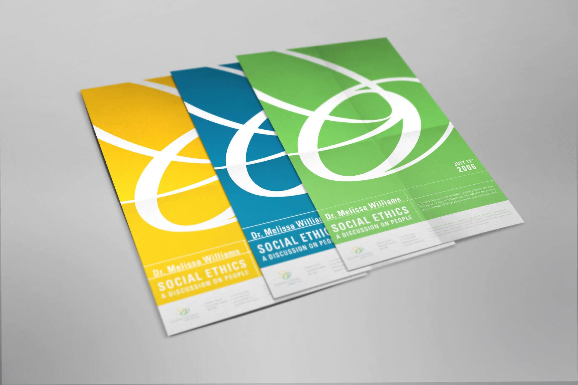 Three brochures on social ethics are stacked on top of each other