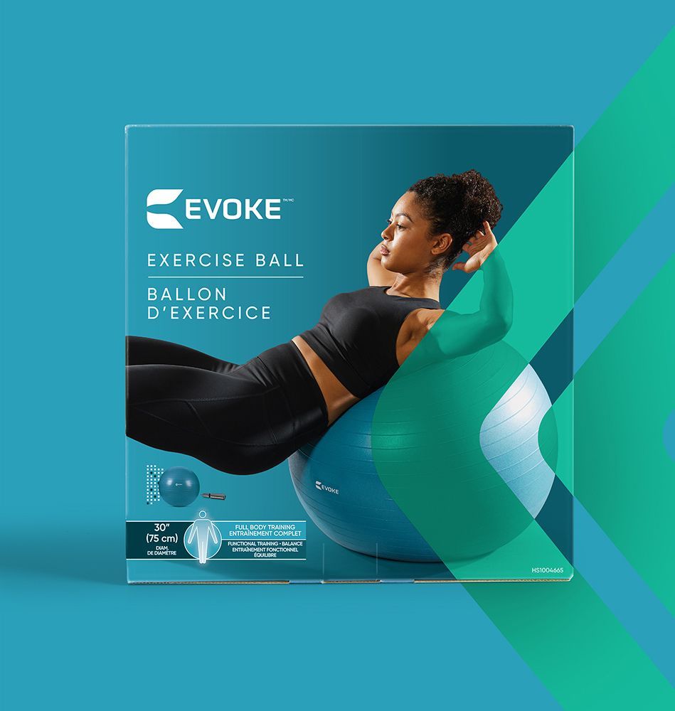 A woman is laying on an exercise ball in a box.