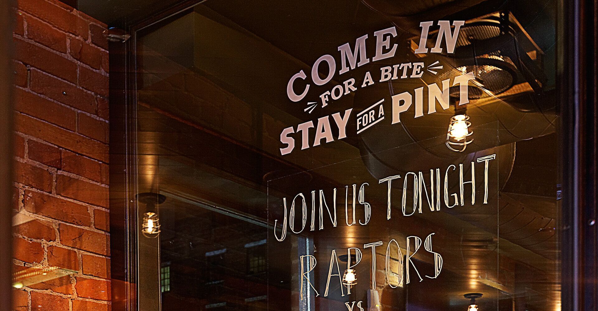 A sign that says come in for a bite stay at the pint