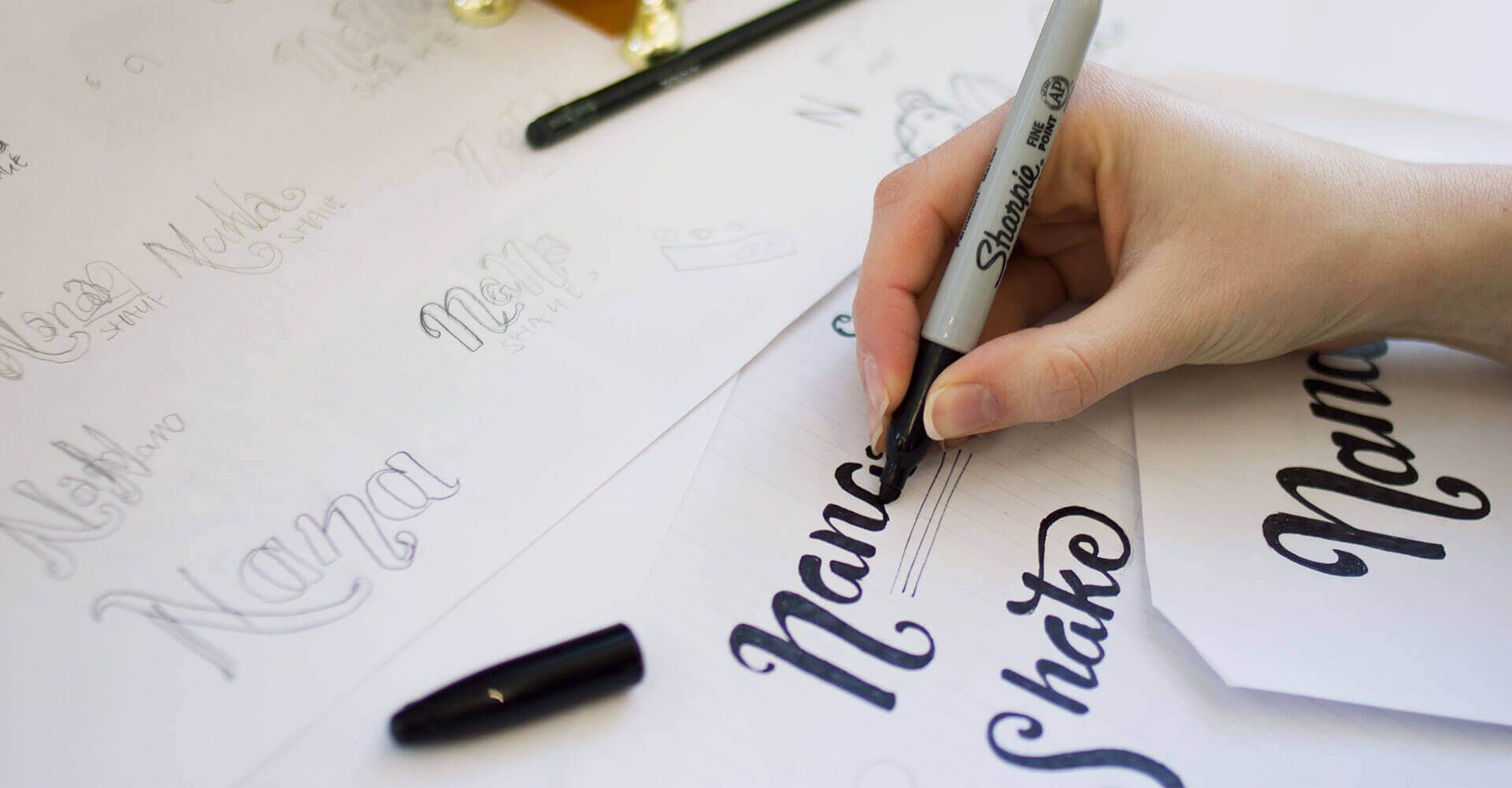 A bunch of logos for nana shake are on a white surface.