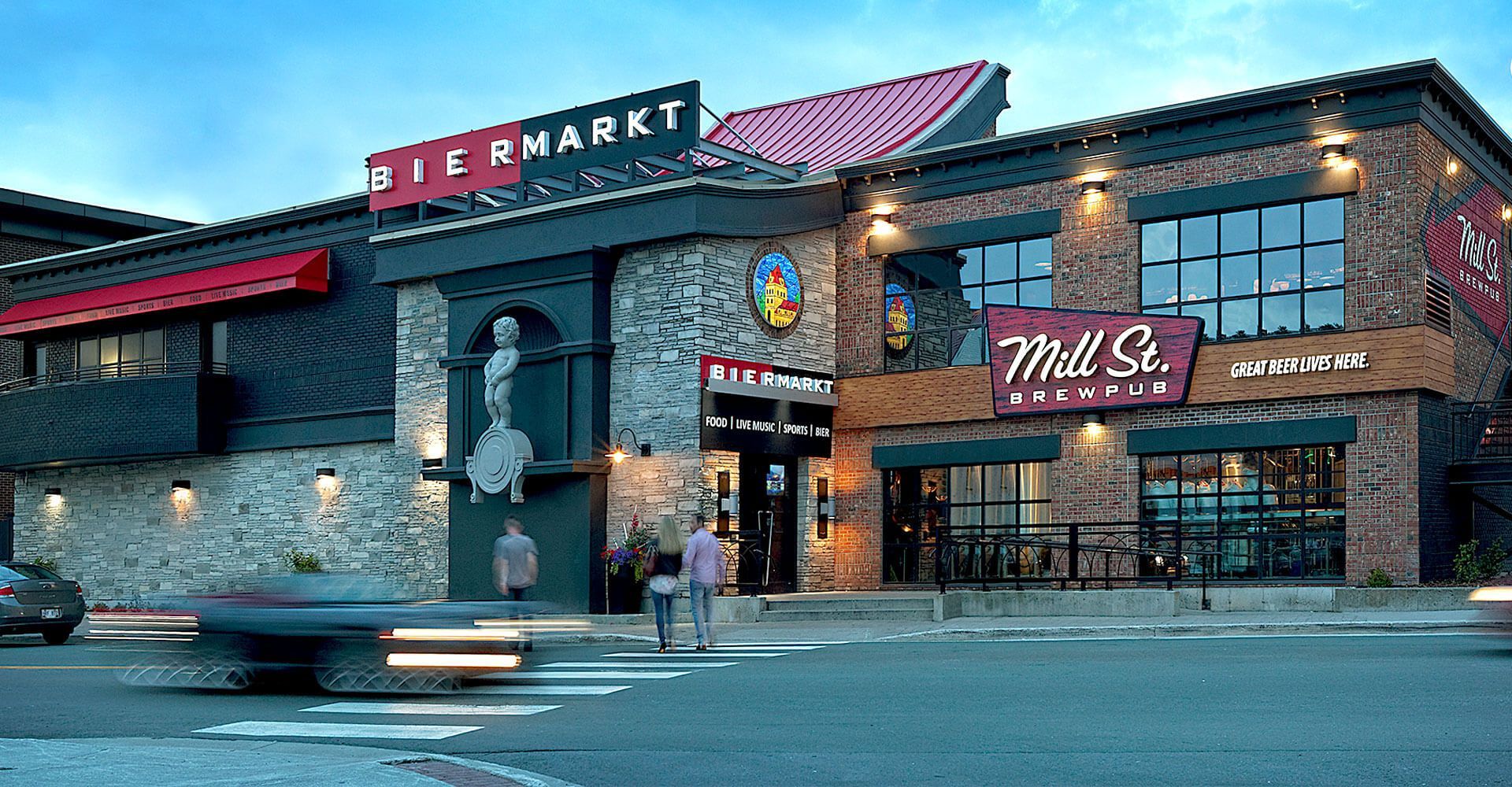 A brick building with a red sign that says mill st.