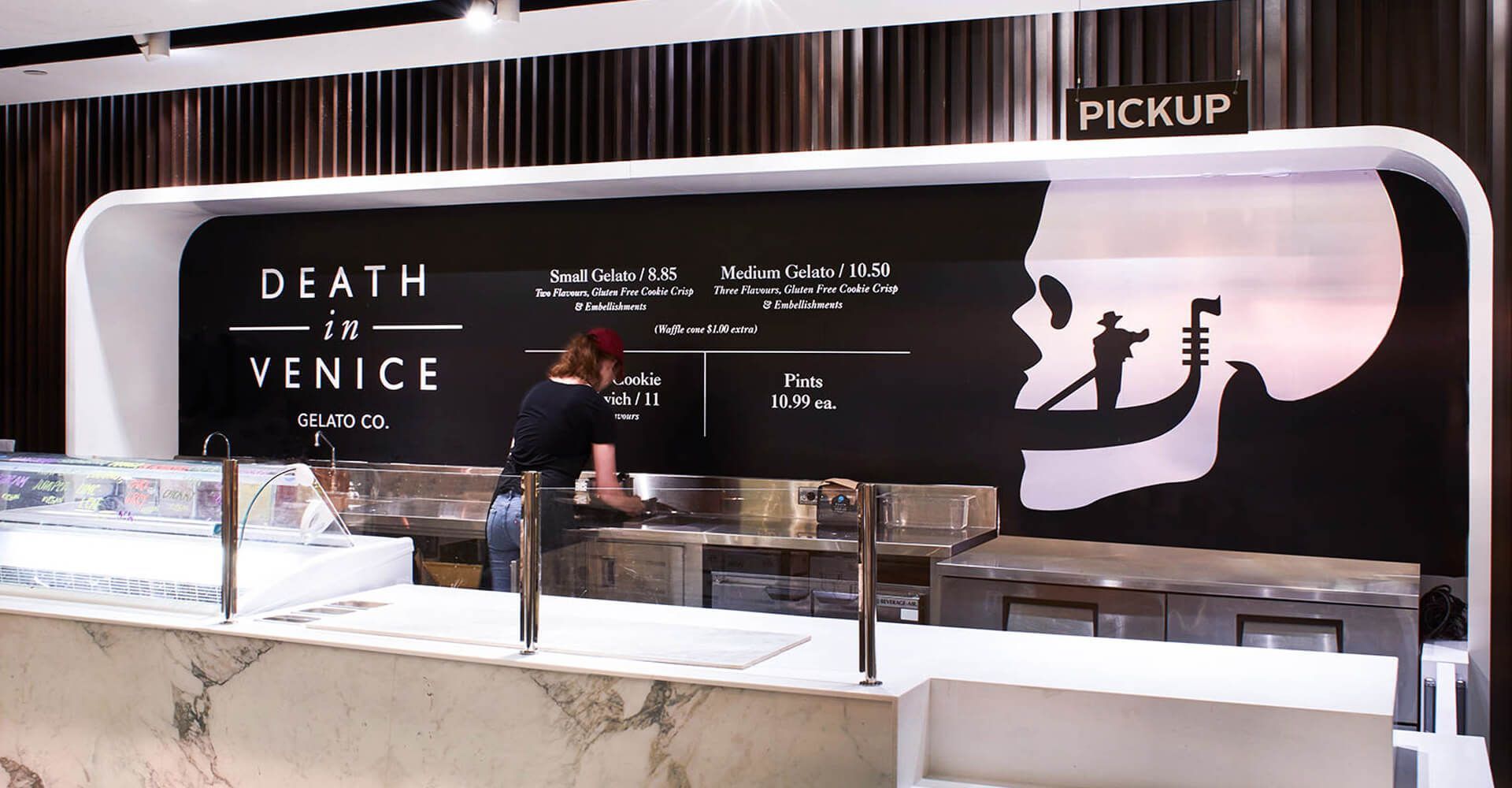 a barista cleaning dishest behind the death in venice counter.
