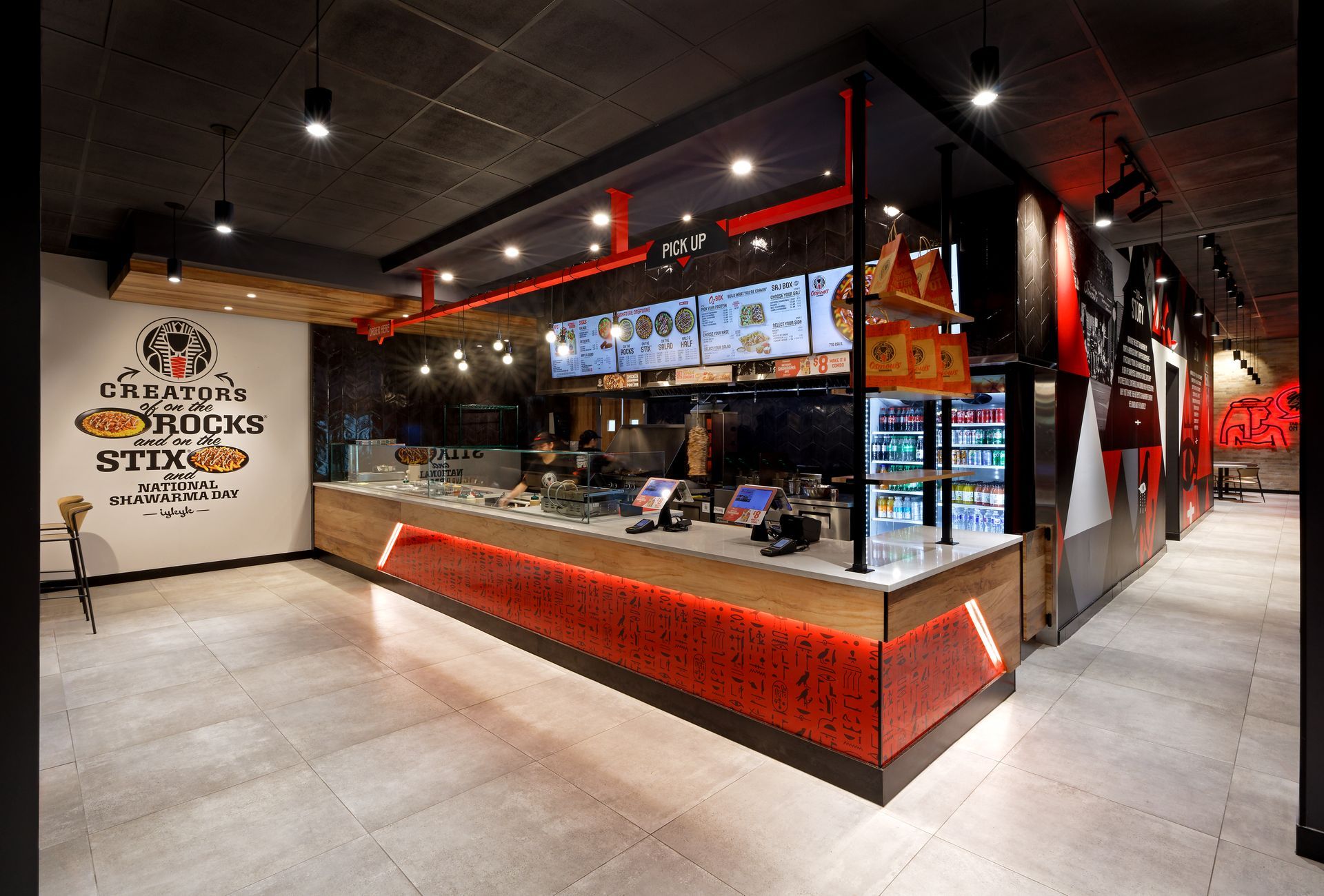 A restaurant with a counter and a sign that says ' shawarma ' on it