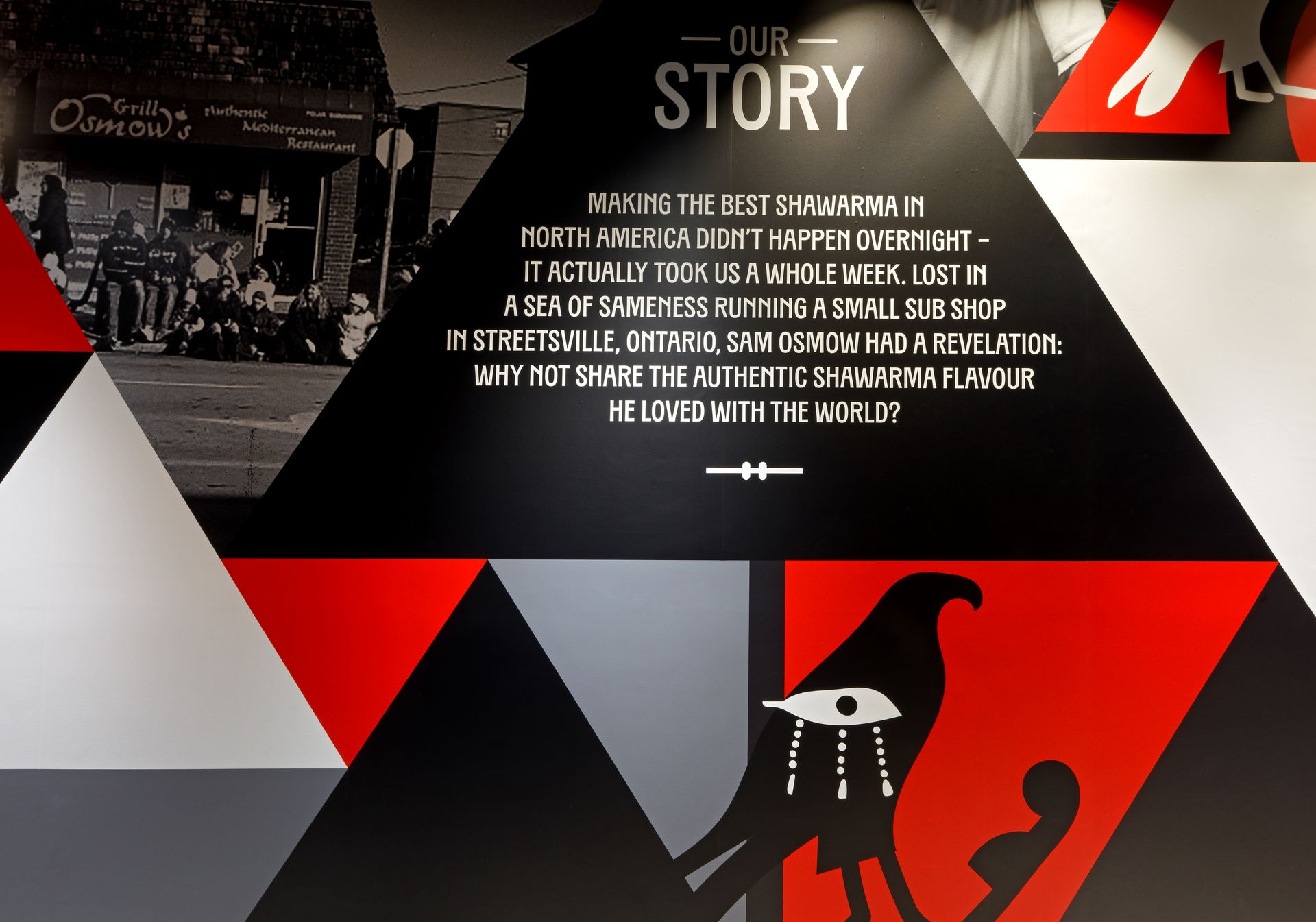 A wall with a triangle that says our story on it