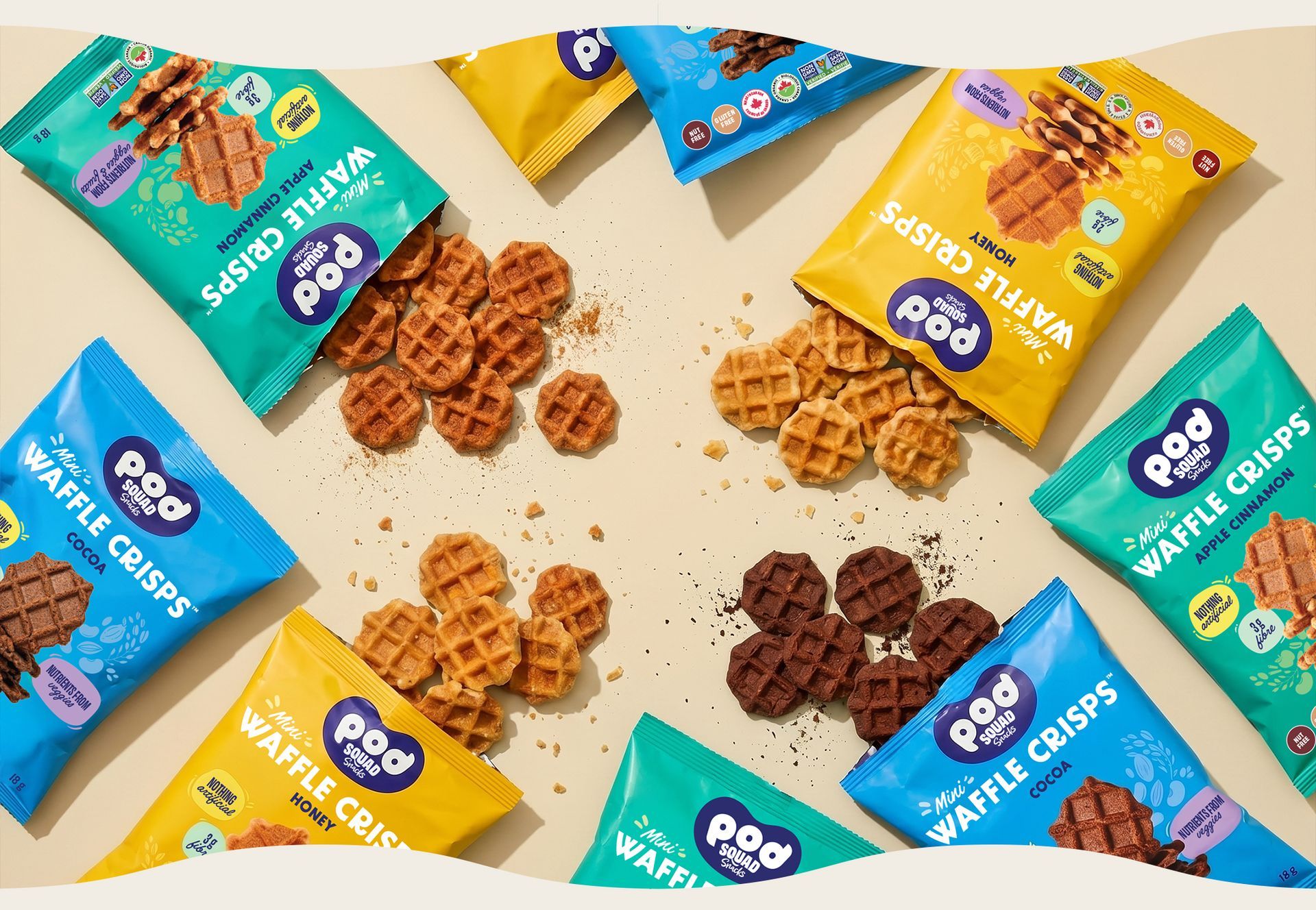 Assorted colorful snack packs and spilled cookies arranged on a beige background