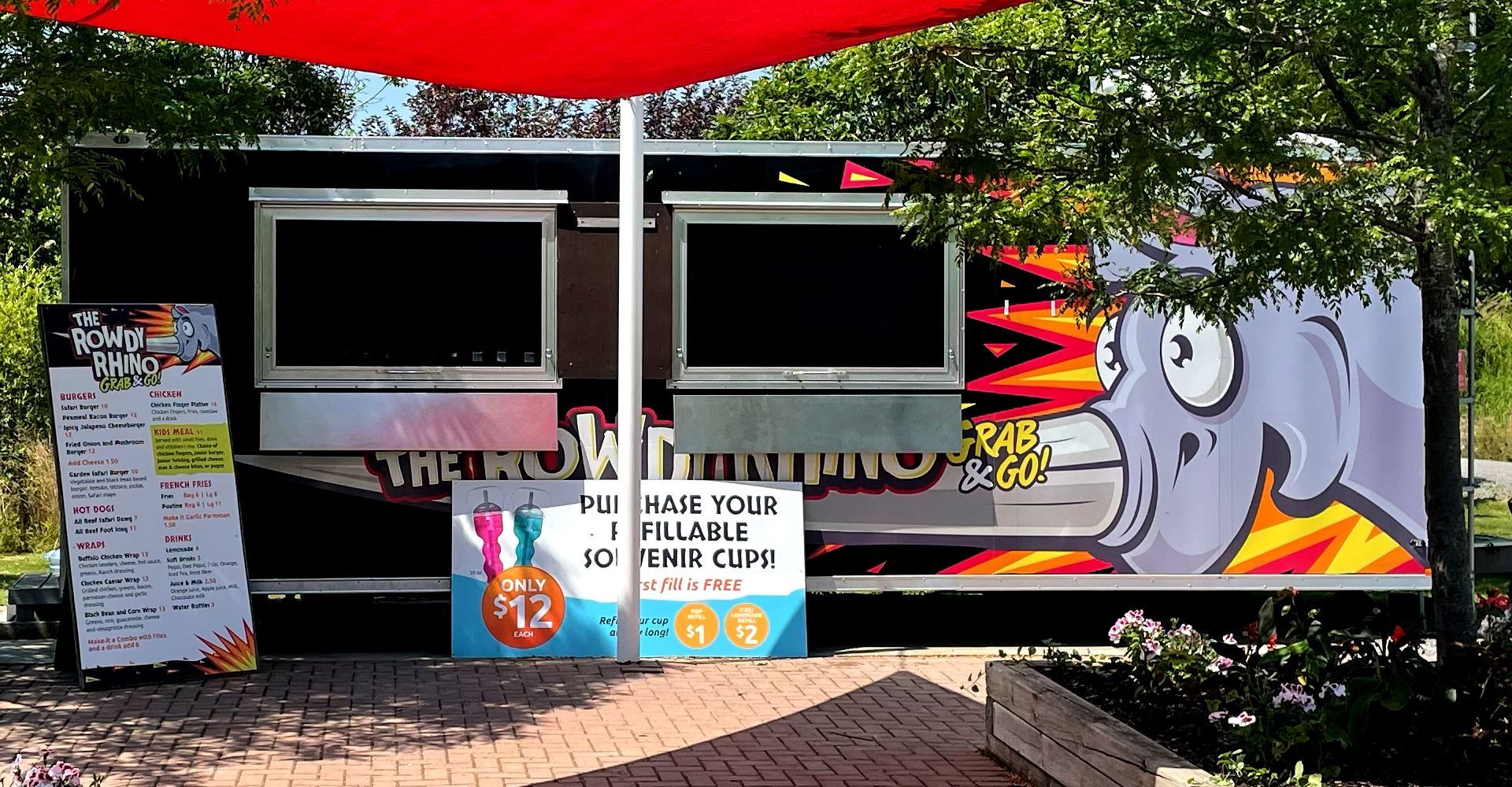 A food truck with a cartoon drawing of an octopus on the side.