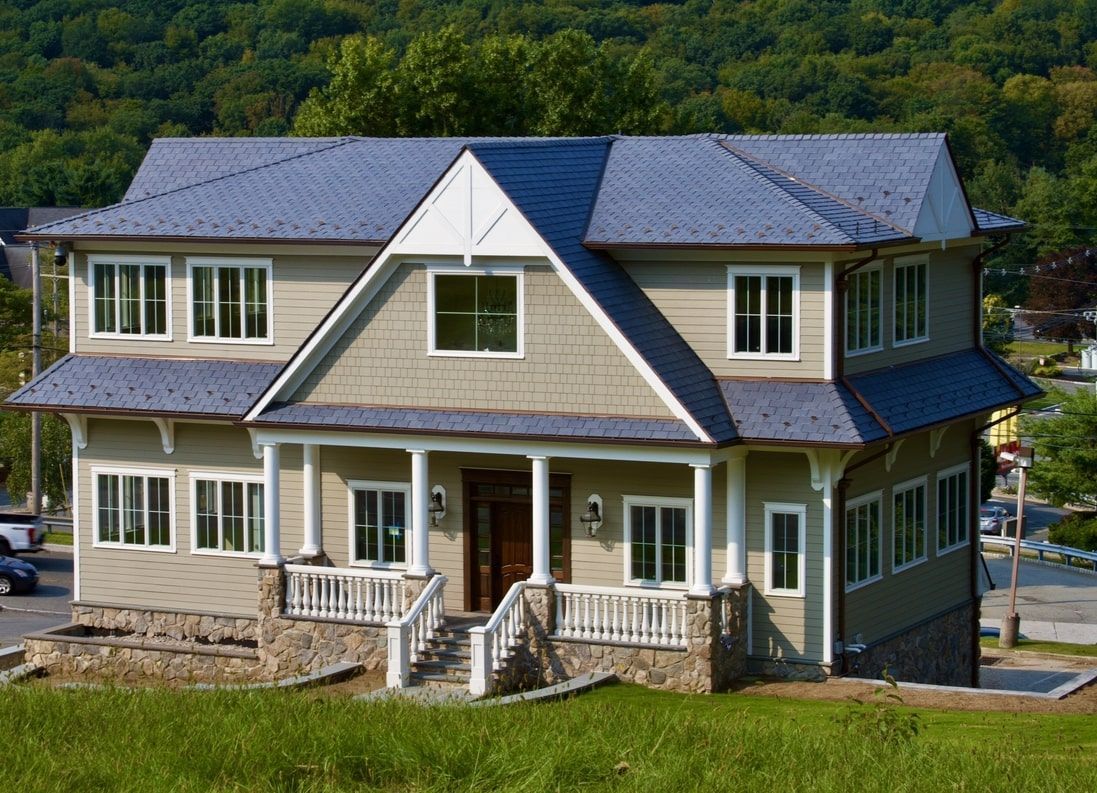 Successful roof replacement NJ project showing the transformation of an old roof to a modern GAF system.