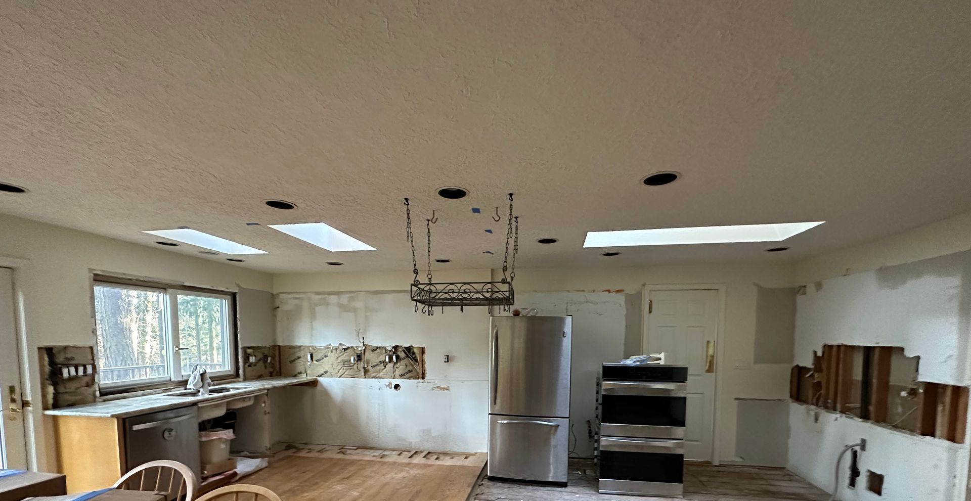 A kitchen with a refrigerator , stove , dishwasher , and sink.