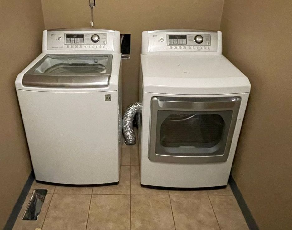 A washer and dryer are sitting next to each other in a laundry room.