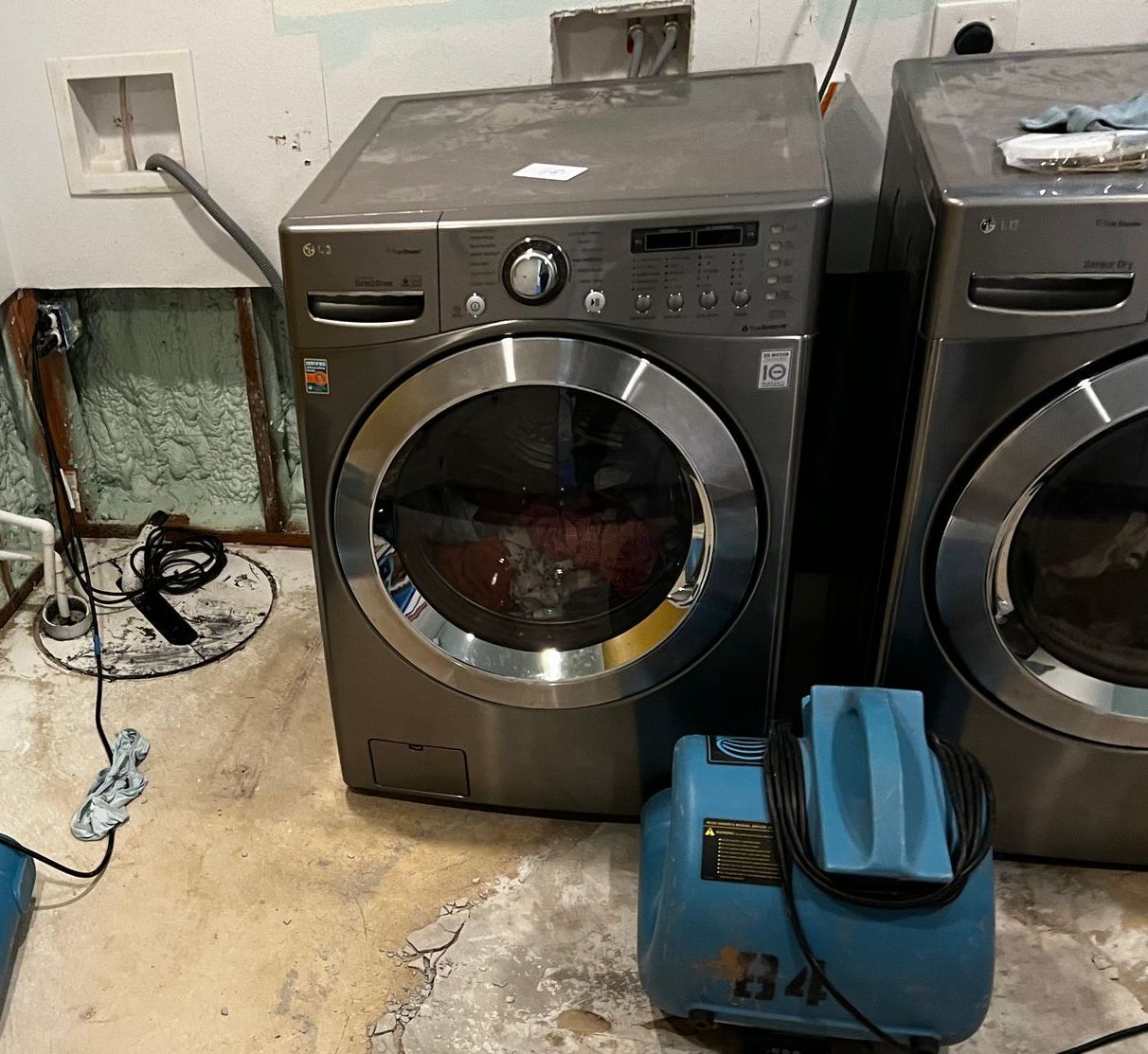A washer and dryer are sitting next to each other in a laundry room.