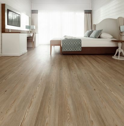 A bedroom with hardwood floors and a large bed