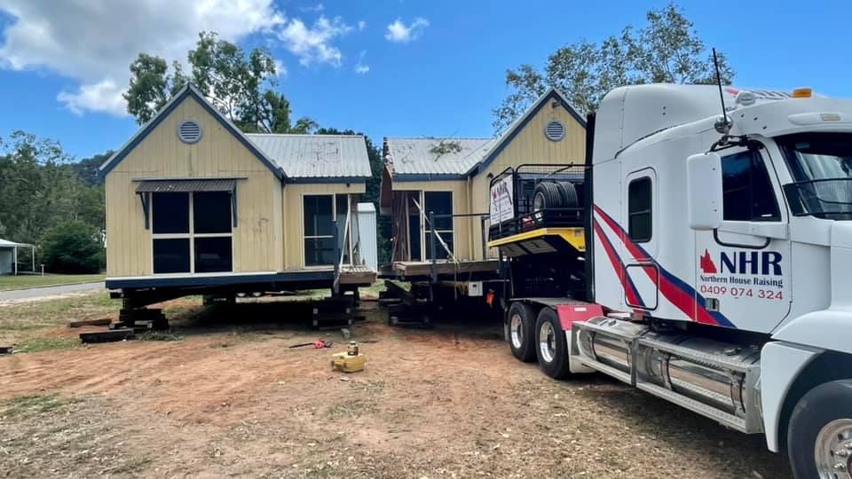 Couple of Houses Being Transported — House Lifting Services in Garbutt, QLD